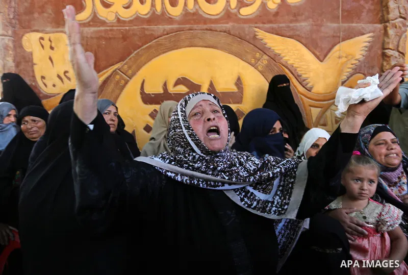 A Palestinian woman reacts during the funeral of a 25-year-old Palestinian Fadi al-Najjar who was killed by Israeli fire in the Gaza Strip during clashes with Israeli sceurity forces at the border fence the previous day,...