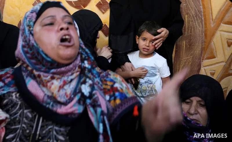 A Palestinian woman reacts during the funeral of a 25-year-old Palestinian Fadi al-Najjar who was killed by Israeli fire in the Gaza Strip during clashes with Israeli sceurity forces at the border fence the previous day,...