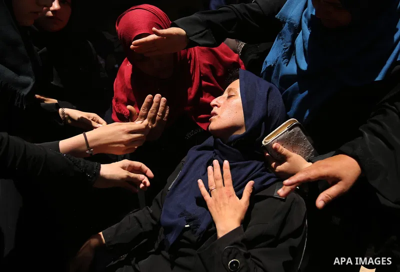 Palestinian women react during the funeral of a 25-year-old Palestinian Fadi al-Najjar who was killed by Israeli fire in the Gaza Strip during clashes with Israeli sceurity forces at the border fence the previous day, in...