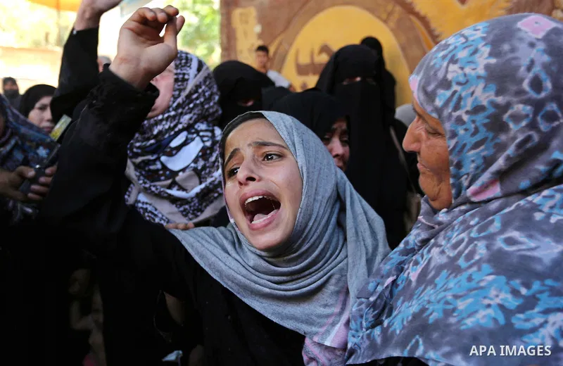 Palestinian women react during the funeral of a 25-year-old Palestinian Fadi al-Najjar who was killed by Israeli fire in the Gaza Strip during clashes with Israeli sceurity forces at the border fence the previous day, in...