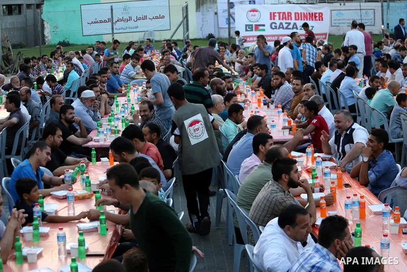 Palestinian Muslims eat their Iftar meal as they break their fast during the holy fasting month of Ramadan, in Gaza city on June 8, 2017. Ramadan is sacred to Muslims because it is during that month that tradition says t...