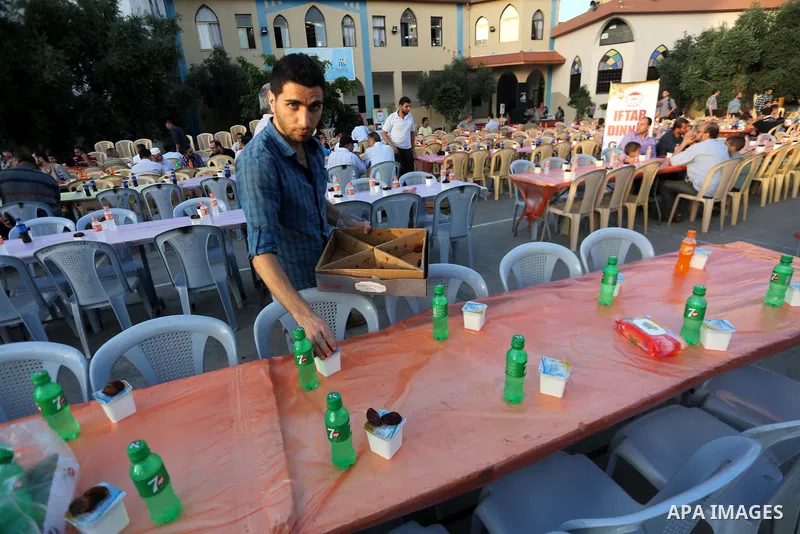Palestinian Muslims eat their Iftar meal as they break their fast during the holy fasting month of Ramadan, in Gaza city on June 8, 2017. Ramadan is sacred to Muslims because it is during that month that tradition says t...
