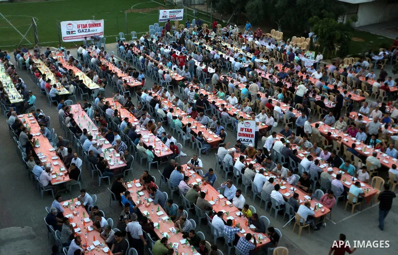 Palestinian Muslims eat their Iftar meal as they break their fast during the holy fasting month of Ramadan, in Gaza city on June 8, 2017. Ramadan is sacred to Muslims because it is during that month that tradition says t...