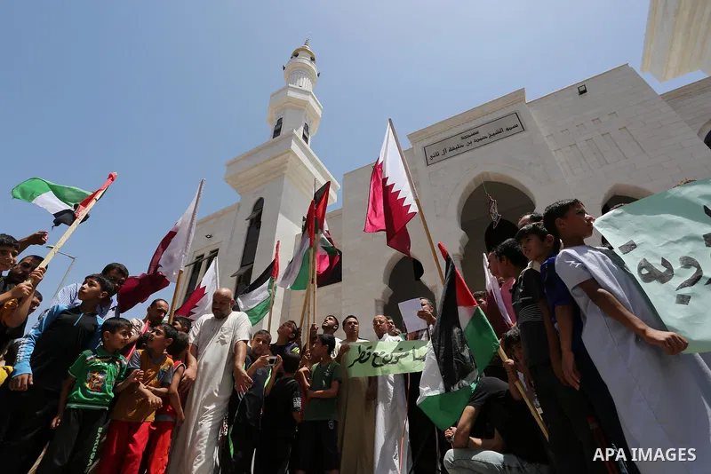 Palestinians take part in a rally in support of Qatar, inside Qatari-funded construction project 'Hamad City', in Khan Younis in the southern Gaza Strip, June 9, 2017. Photo by Ashraf Amra