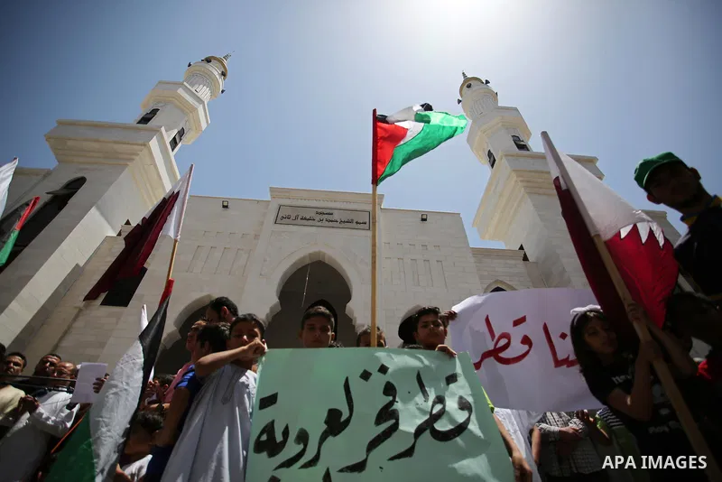 Palestinians take part in a rally in support of Qatar, inside Qatari-funded construction project 'Hamad City', in Khan Younis in the southern Gaza Strip, June 9, 2017. Photo by Ashraf Amra