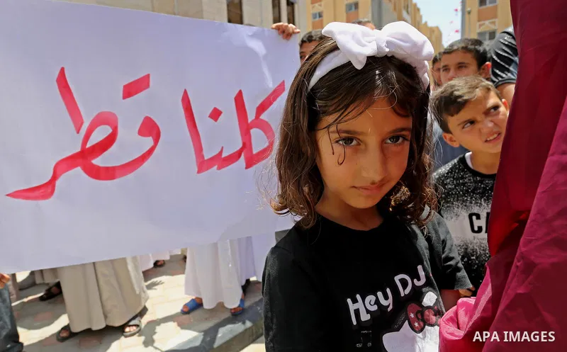 Palestinians take part in a rally in support of Qatar, inside Qatari-funded construction project 'Hamad City', in Khan Younis in the southern Gaza Strip, June 9, 2017. Photo by Ashraf Amra