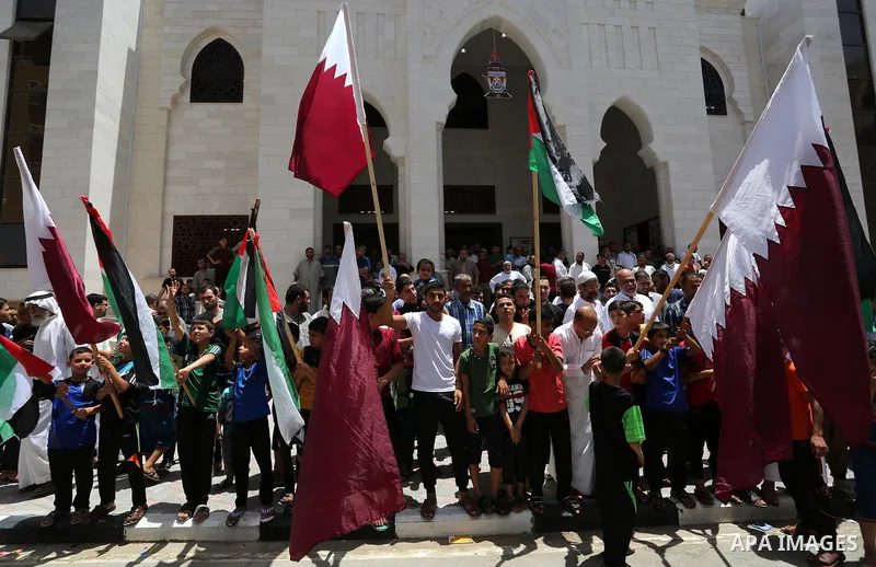 Palestinians take part in a rally in support of Qatar, inside Qatari-funded construction project 'Hamad City', in Khan Younis in the southern Gaza Strip, June 9, 2017. Photo by Ashraf Amra