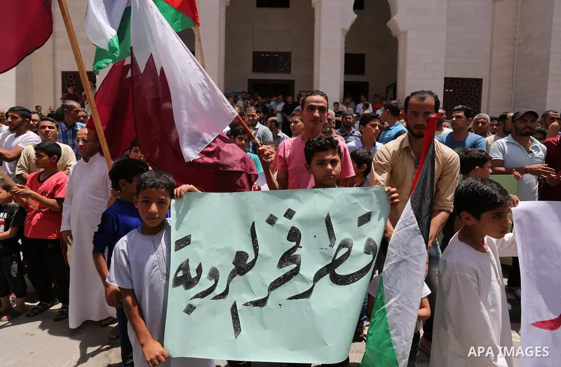 Palestinians take part in a rally in support of Qatar, inside Qatari-funded construction project 'Hamad City', in Khan Younis in the southern Gaza Strip, June 9, 2017. Photo by Ashraf Amra