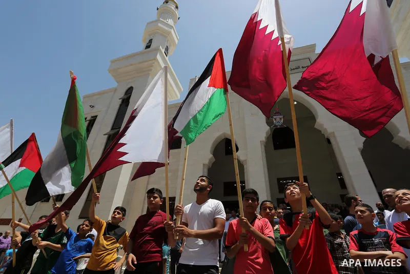 Palestinians take part in a rally in support of Qatar, inside Qatari-funded construction project 'Hamad City', in Khan Younis in the southern Gaza Strip, June 9, 2017. Photo by Ashraf Amra
