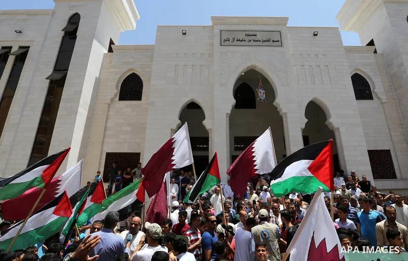Palestinians take part in a rally in support of Qatar, inside Qatari-funded construction project 'Hamad City', in Khan Younis in the southern Gaza Strip, June 9, 2017. Photo by Ashraf Amra
