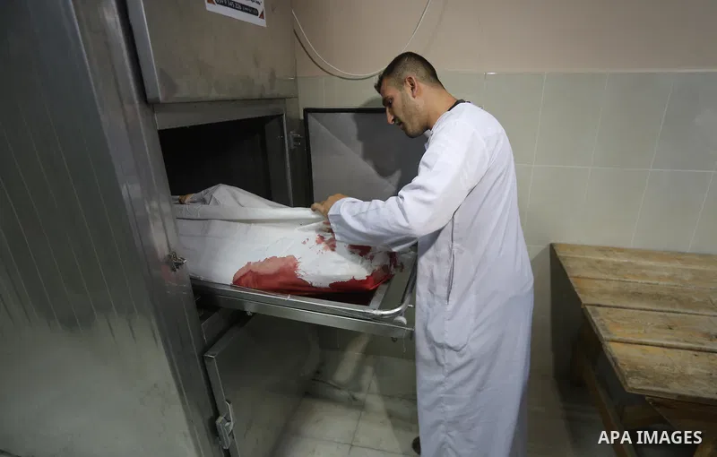 A relative mourns over the body of Palestinian Aaed Goma at a hospital morgue in the northern Gaza Strip June 9, 2017. Photo by Mohammed Asad