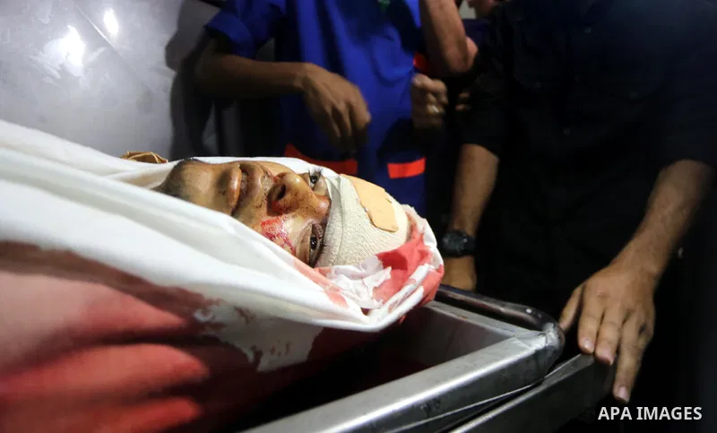 A relative mourns over the body of Palestinian Aaed Goma at a hospital morgue in the northern Gaza Strip June 9, 2017. Photo by Mohammed Asad