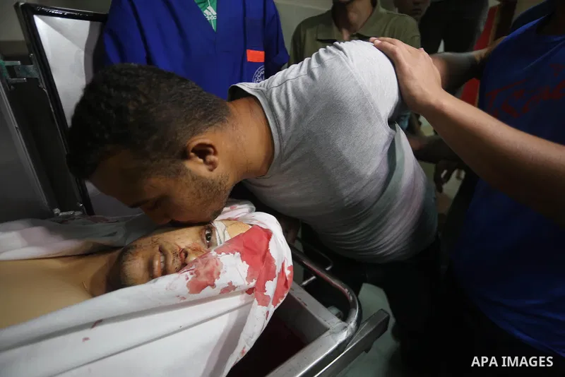 A relative mourns over the body of Palestinian Aaed Goma at a hospital morgue in the northern Gaza Strip June 9, 2017. Photo by Mohammed Asad
