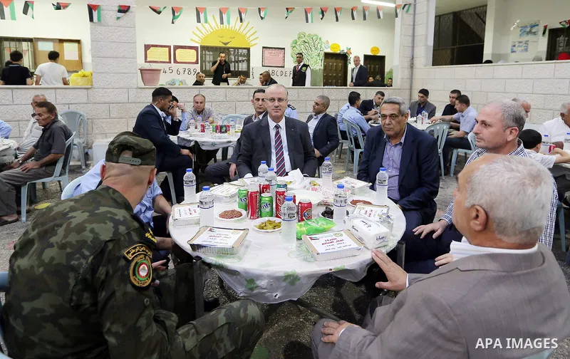 Palestinian Prime Minister Rami Hamdallah takes part in breakfast for orphans on holy fasting month of Ramadan, in the West Bank city of Tulkarem, on June 09, 2017. Photo by Prime Minister Office