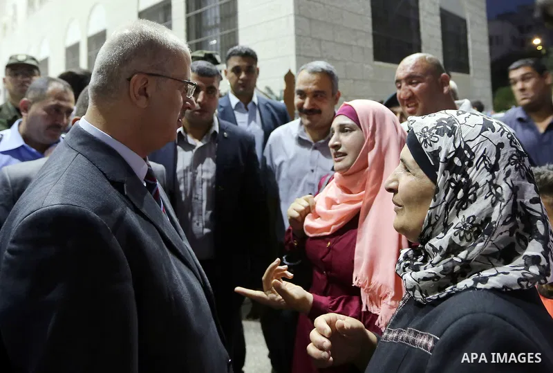 Palestinian Prime Minister Rami Hamdallah takes part in breakfast for orphans on holy fasting month of Ramadan, in the West Bank city of Tulkarem, on June 09, 2017. Photo by Prime Minister Office