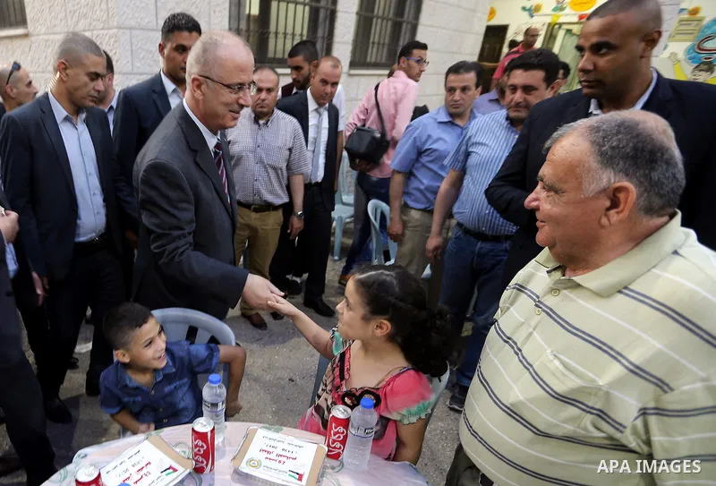 Palestinian Prime Minister Rami Hamdallah takes part in breakfast for orphans on holy fasting month of Ramadan, in the West Bank city of Tulkarem, on June 09, 2017. Photo by Prime Minister Office