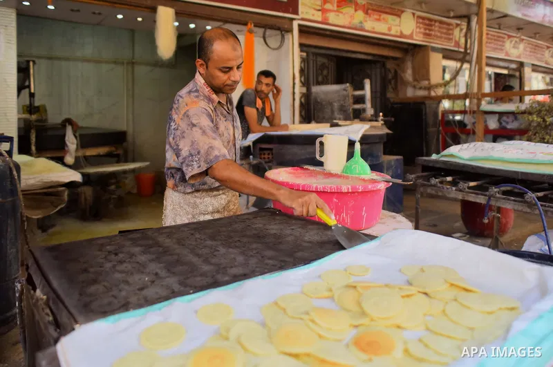 An Egyptian vendor prepares traditional pancakes known as ''Qatayef'' on the Muslim holy fasting month of Ramadan at market in Cairo, Egypt, on June 10, 2017. Ramadan is sacred to Muslims because it is during that month...