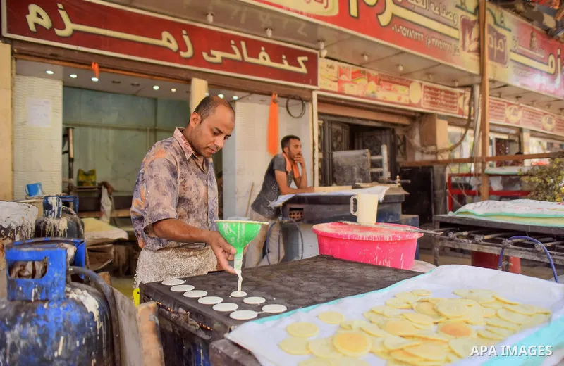 An Egyptian vendor prepares traditional pancakes known as ''Qatayef'' on the Muslim holy fasting month of Ramadan at market in Cairo, Egypt, on June 10, 2017. Ramadan is sacred to Muslims because it is during that month...