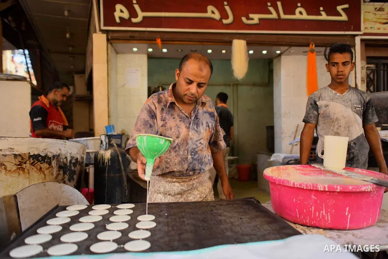 An Egyptian vendor prepares traditional pancakes known as ''Qatayef'' on the Muslim holy fasting month of Ramadan at market in Cairo, Egypt, on June 10, 2017. Ramadan is sacred to Muslims because it is during that month...