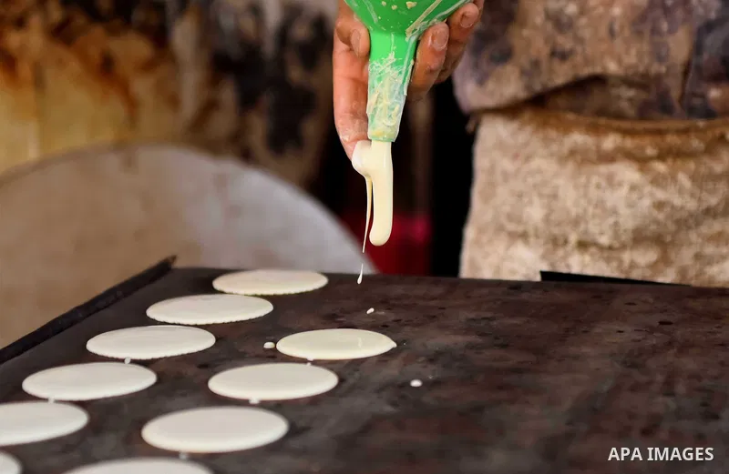 An Egyptian vendor prepares traditional pancakes known as ''Qatayef'' on the Muslim holy fasting month of Ramadan at market in Cairo, Egypt, on June 10, 2017. Ramadan is sacred to Muslims because it is during that month...
