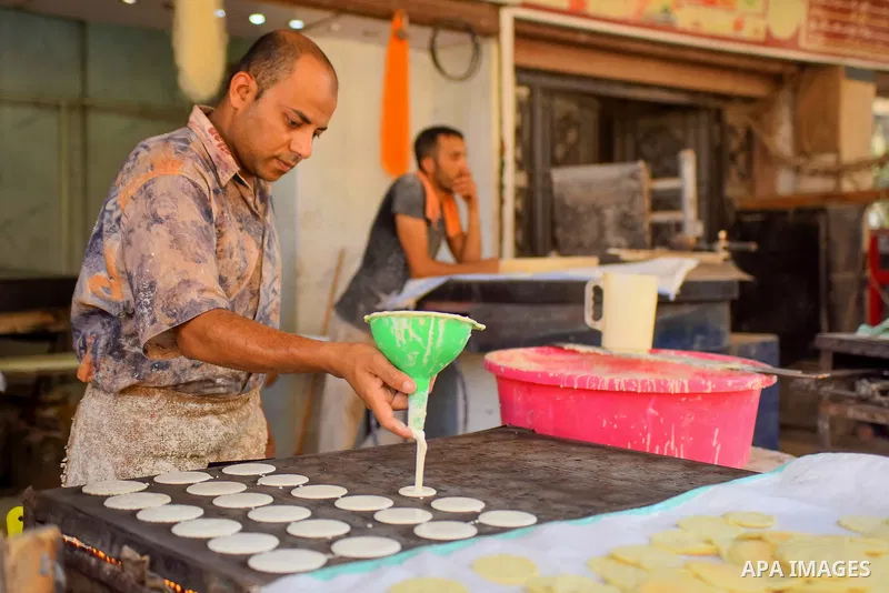 An Egyptian vendor prepares traditional pancakes known as ''Qatayef'' on the Muslim holy fasting month of Ramadan at market in Cairo, Egypt, on June 10, 2017. Ramadan is sacred to Muslims because it is during that month...