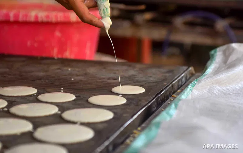 An Egyptian vendor prepares traditional pancakes known as ''Qatayef'' on the Muslim holy fasting month of Ramadan at market in Cairo, Egypt, on June 10, 2017. Ramadan is sacred to Muslims because it is during that month...