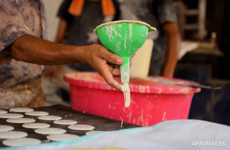 An Egyptian vendor prepares traditional pancakes known as ''Qatayef'' on the Muslim holy fasting month of Ramadan at market in Cairo, Egypt, on June 10, 2017. Ramadan is sacred to Muslims because it is during that month...