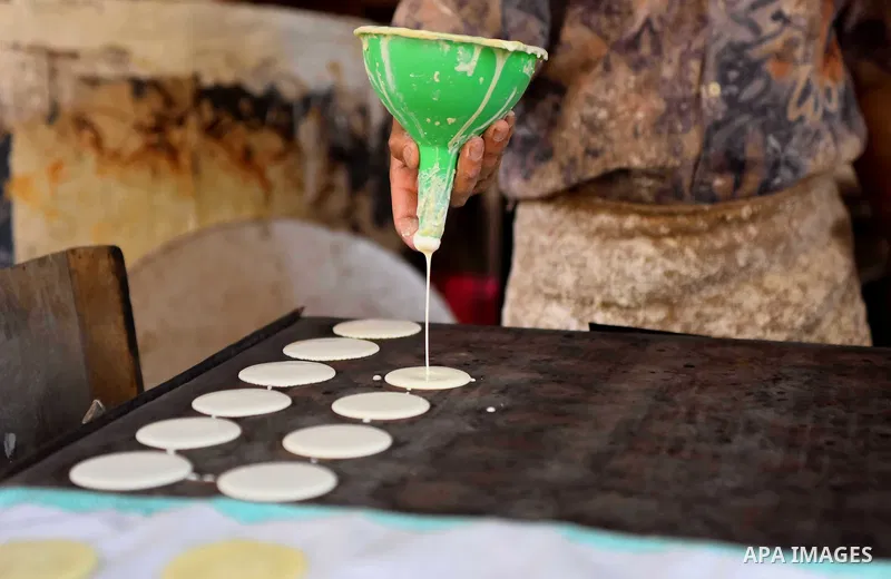 An Egyptian vendor prepares traditional pancakes known as ''Qatayef'' on the Muslim holy fasting month of Ramadan at market in Cairo, Egypt, on June 10, 2017. Ramadan is sacred to Muslims because it is during that month...