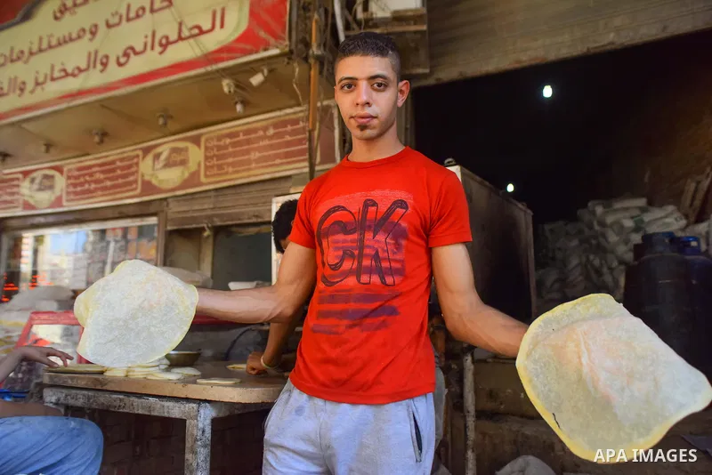 An Egyptian vendor prepares breads on the Muslim holy fasting month of Ramadan at market in Cairo, Egypt, on June 10, 2017. Ramadan is sacred to Muslims because it is during that month that tradition says the Koran was r...