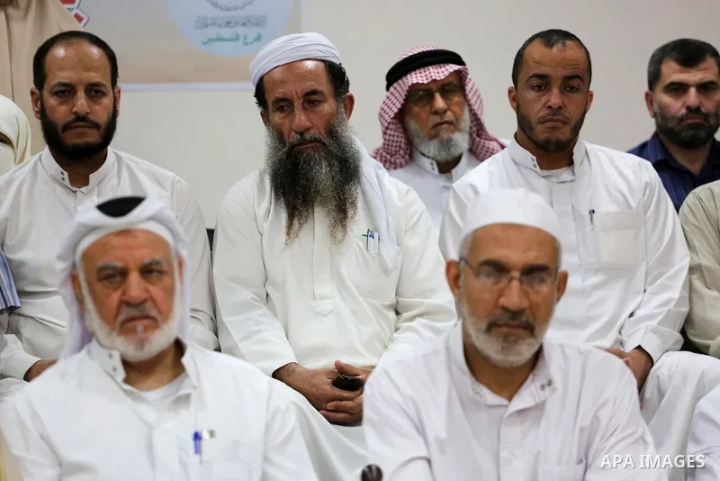 Members of Palestine Scholars Association attend a press conference to show solidarity with Sheikh Yusuf al-Qaradawi in Gaza city on June 11, 2017. The Muslim World League announced the termination of the membership of Y...