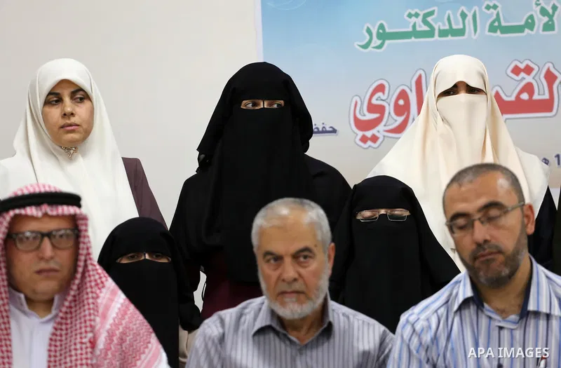 Members of Palestine Scholars Association attend a press conference to show solidarity with Sheikh Yusuf al-Qaradawi in Gaza city on June 11, 2017. The Muslim World League announced the termination of the membership of Y...
