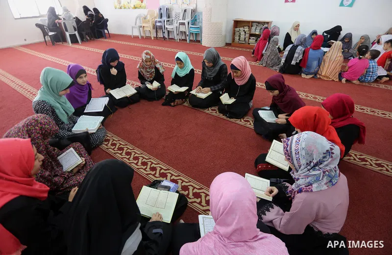 Palestinian girls attend a lesson of Koran, Islam's holiest book on the Muslim holy fasting month of Ramadan, at Dar Al Ketab and Sunna in Gaza city, on June 12, 2017. Ramadan is sacred to Muslims because it is during th...