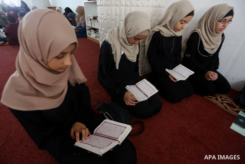 Palestinian girls attend a lesson of Koran, Islam's holiest book on the Muslim holy fasting month of Ramadan, at Dar Al Ketab and Sunna in Gaza city, on June 12, 2017. Ramadan is sacred to Muslims because it is during th...