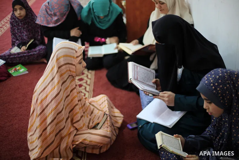 Palestinian girls attend a lesson of Koran, Islam's holiest book on the Muslim holy fasting month of Ramadan, at Dar Al Ketab and Sunna in Gaza city, on June 12, 2017. Ramadan is sacred to Muslims because it is during th...