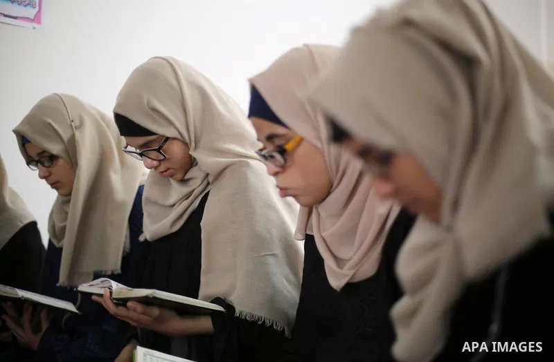 Palestinian girls attend a lesson of Koran, Islam's holiest book on the Muslim holy fasting month of Ramadan, at Dar Al Ketab and Sunna in Gaza city, on June 12, 2017. Ramadan is sacred to Muslims because it is during th...