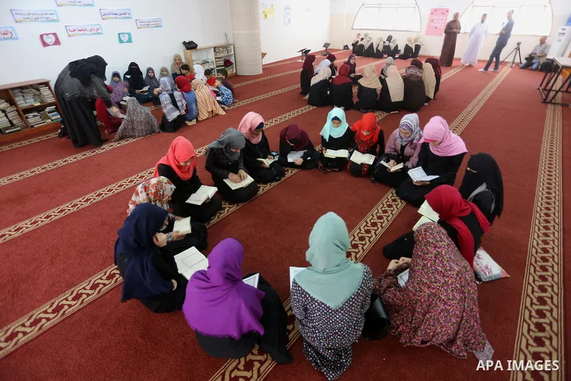 Palestinian girls attend a lesson of Koran, Islam's holiest book on the Muslim holy fasting month of Ramadan, at Dar Al Ketab and Sunna in Gaza city, on June 12, 2017. Ramadan is sacred to Muslims because it is during th...