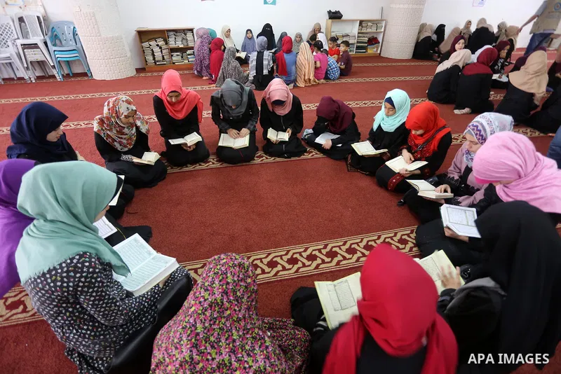 Palestinian girls attend a lesson of Koran, Islam's holiest book on the Muslim holy fasting month of Ramadan, at Dar Al Ketab and Sunna in Gaza city, on June 12, 2017. Ramadan is sacred to Muslims because it is during th...