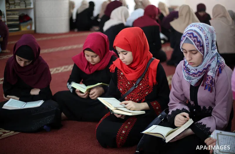 Palestinian girls attend a lesson of Koran, Islam's holiest book on the Muslim holy fasting month of Ramadan, at Dar Al Ketab and Sunna in Gaza city, on June 12, 2017. Ramadan is sacred to Muslims because it is during th...