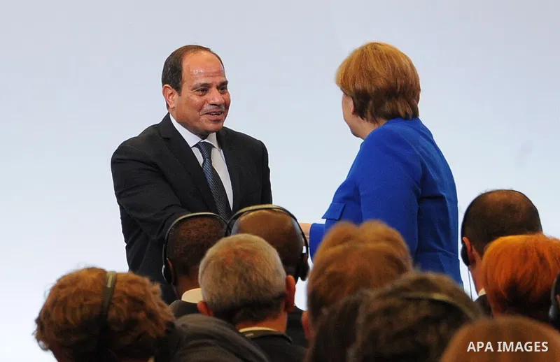 German Chancellor Angela Merkel shakes hands with the President of Egypt, Abdel Fattah el-Sisi during a two-day G20 Africa partnership investment conference in Berlin on June 12, 2017. Photo by Egyptian President Office