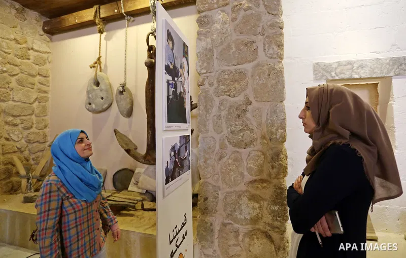 Palestinians participate in a photo gallery organized by Red cross (ICRC) on the occasion of over 50 years of its presence in the occupied Palestinian territories, in Gaza city on June 13, 2017. Photo by Ashraf Amra