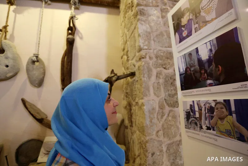 Palestinians participate in a photo gallery organized by Red cross (ICRC) on the occasion of over 50 years of its presence in the occupied Palestinian territories, in Gaza city on June 13, 2017. Photo by Ashraf Amra
