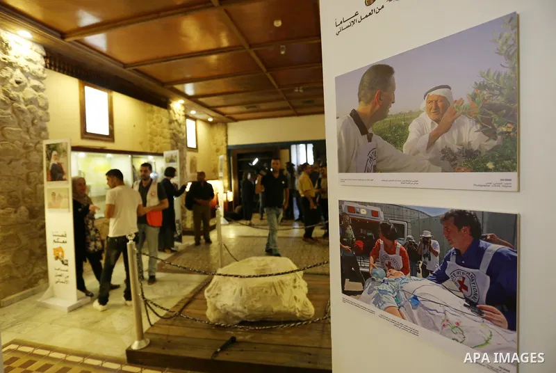 Palestinians participate in a photo gallery organized by Red cross (ICRC) on the occasion of over 50 years of its presence in the occupied Palestinian territories, in Gaza city on June 13, 2017. Photo by Ashraf Amra