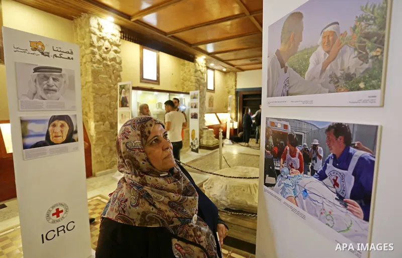 Palestinians participate in a photo gallery organized by Red cross (ICRC) on the occasion of over 50 years of its presence in the occupied Palestinian territories, in Gaza city on June 13, 2017. Photo by Ashraf Amra