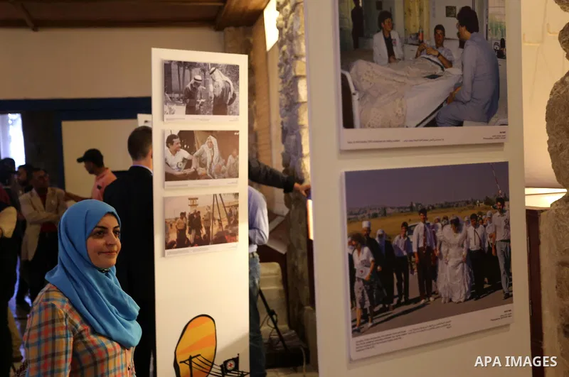 Palestinians participate in a photo gallery organized by Red cross (ICRC) on the occasion of over 50 years of its presence in the occupied Palestinian territories, in Gaza city on June 13, 2017. Photo by Ashraf Amra