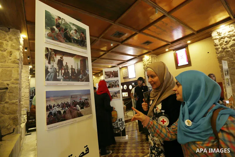 Palestinians participate in a photo gallery organized by Red cross (ICRC) on the occasion of over 50 years of its presence in the occupied Palestinian territories, in Gaza city on June 13, 2017. Photo by Ashraf Amra