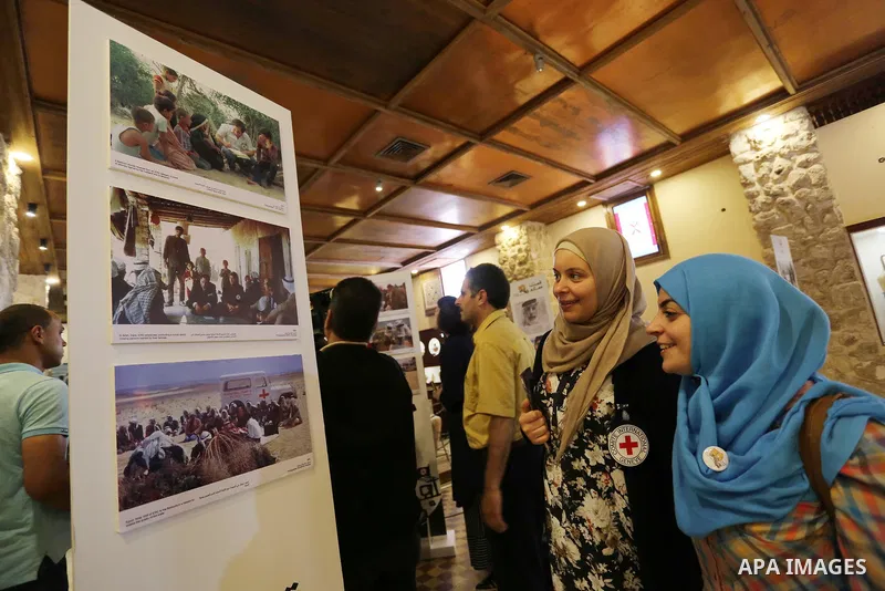 Palestinians participate in a photo gallery organized by Red cross (ICRC) on the occasion of over 50 years of its presence in the occupied Palestinian territories, in Gaza city on June 13, 2017. Photo by Ashraf Amra