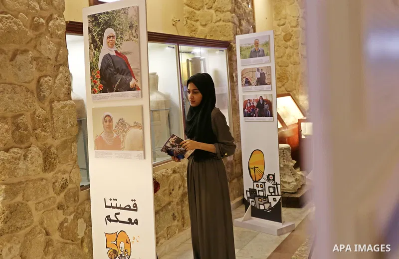 Palestinians participate in a photo gallery organized by Red cross (ICRC) on the occasion of over 50 years of its presence in the occupied Palestinian territories, in Gaza city on June 13, 2017. Photo by Ashraf Amra