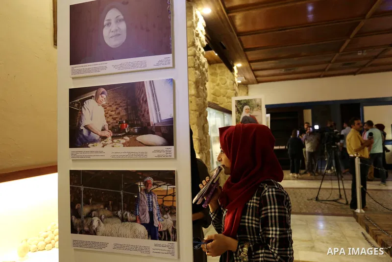 Palestinians participate in a photo gallery organized by Red cross (ICRC) on the occasion of over 50 years of its presence in the occupied Palestinian territories, in Gaza city on June 13, 2017. Photo by Ashraf Amra