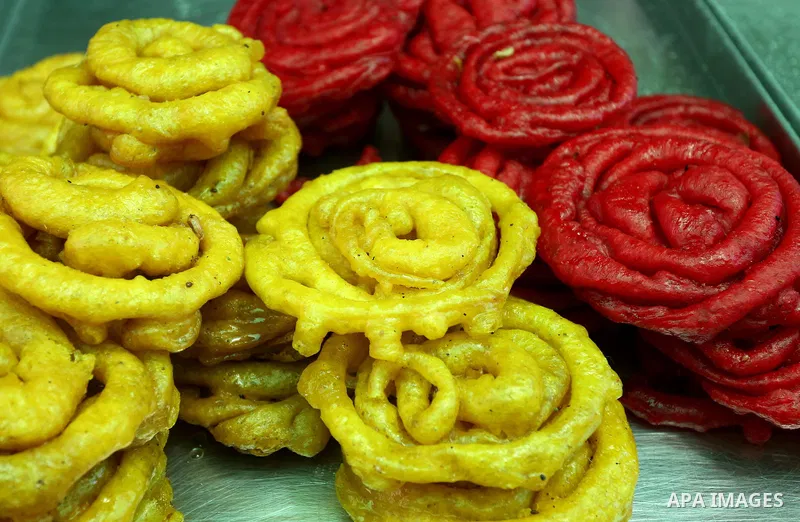 A Palestinian vendor preparers a traditional sweets at a market on the Muslim holy fasting month of Ramadan in the Old City of the West Bank town of Nablus, on June 13, 2017. Ramadan is sacred to Muslims because it is du...