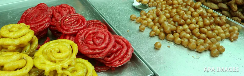 A Palestinian vendor preparers a traditional sweets at a market on the Muslim holy fasting month of Ramadan in the Old City of the West Bank town of Nablus, on June 13, 2017. Ramadan is sacred to Muslims because it is du...
